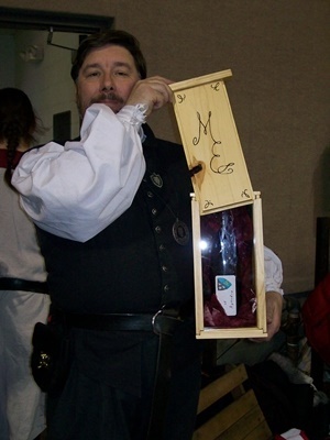 Morgan holding the box showing the glass front with a bottle of cordial inside